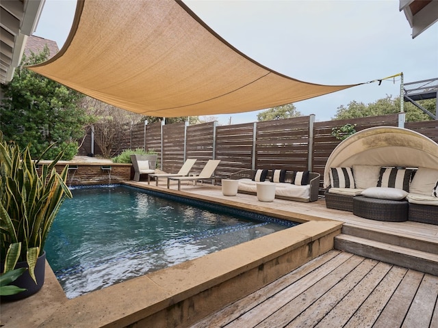 view of pool featuring a wooden deck and outdoor lounge area