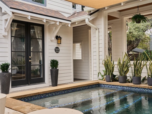 view of swimming pool featuring french doors