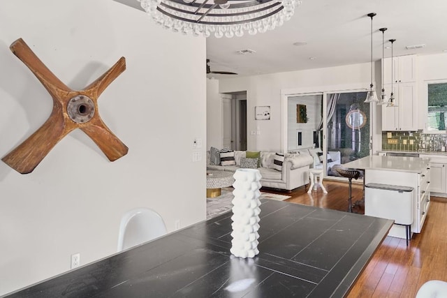 dining space with dark hardwood / wood-style flooring and a chandelier