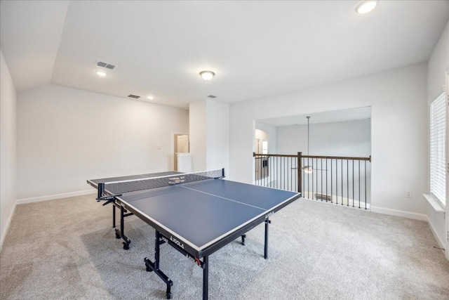 rec room with lofted ceiling and light carpet