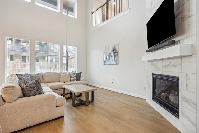 living room featuring light hardwood / wood-style floors and a tile fireplace