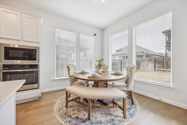 dining space with light hardwood / wood-style flooring