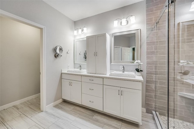 bathroom with vanity and a tile shower