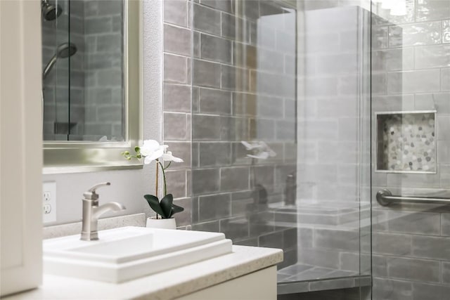 bathroom featuring walk in shower and vanity