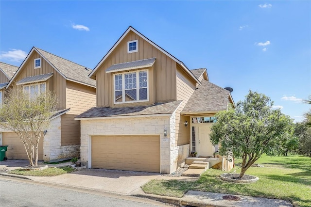 view of front of property with a garage and a front lawn