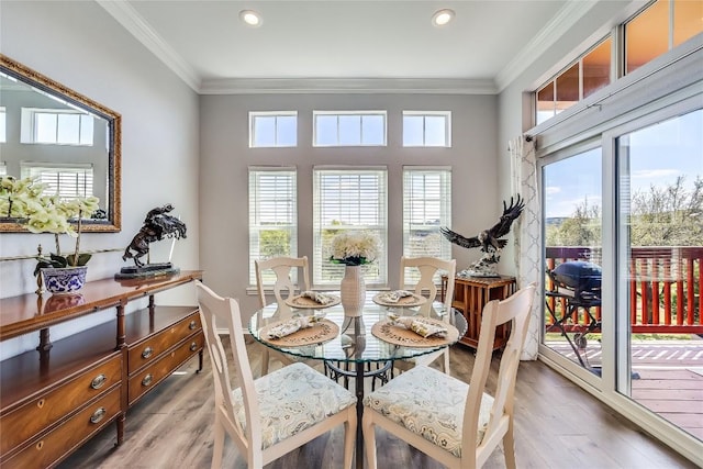 dining room with hardwood / wood-style floors and ornamental molding