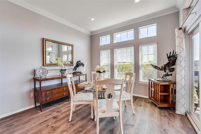 dining area with hardwood / wood-style flooring and ornamental molding