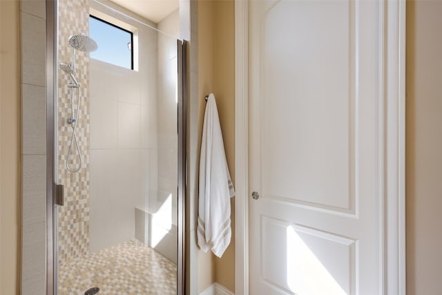 bathroom with a shower with shower door