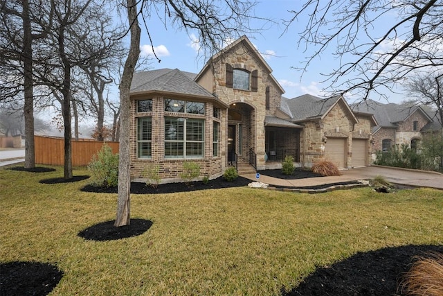 view of front of home with a garage and a front lawn