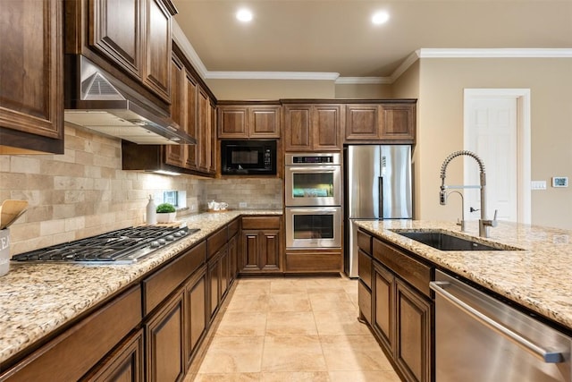 kitchen with light stone counters, sink, crown molding, and stainless steel appliances