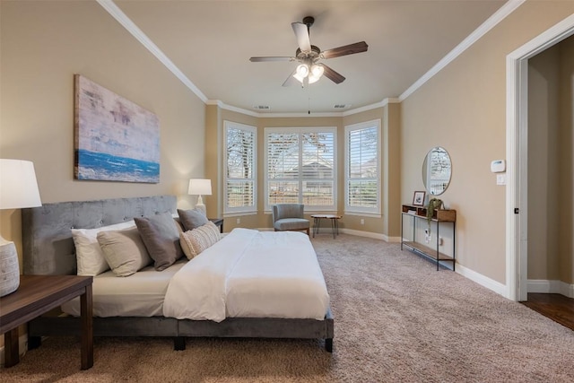 carpeted bedroom with ornamental molding and ceiling fan