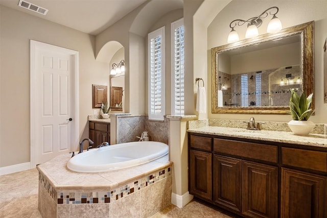 bathroom featuring vanity, separate shower and tub, and tile patterned floors