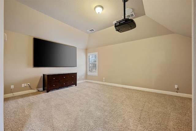 cinema room featuring lofted ceiling and light carpet