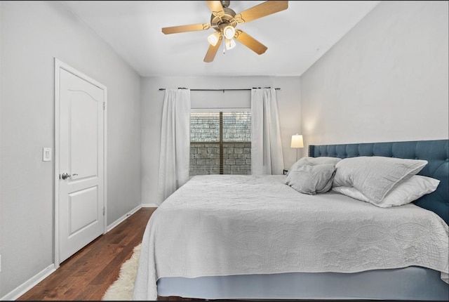 bedroom with dark hardwood / wood-style floors and ceiling fan