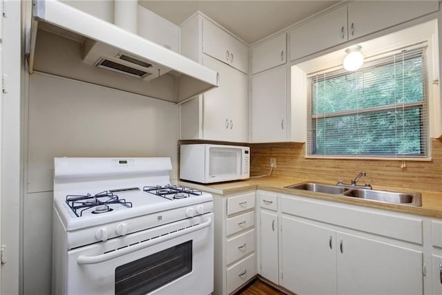 kitchen with white cabinetry, sink, and white appliances