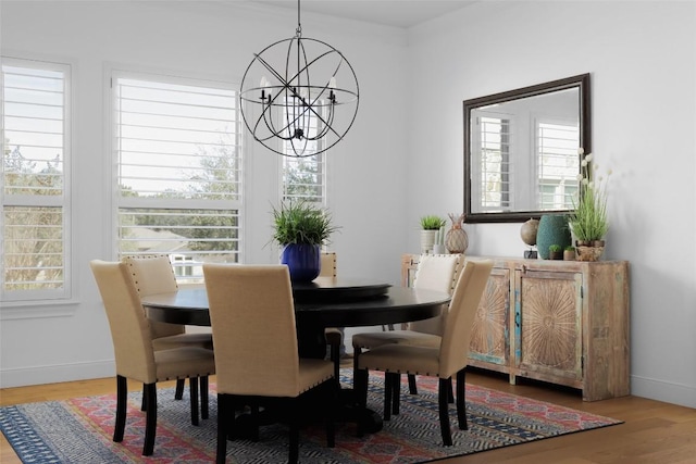 dining space with hardwood / wood-style flooring and a notable chandelier