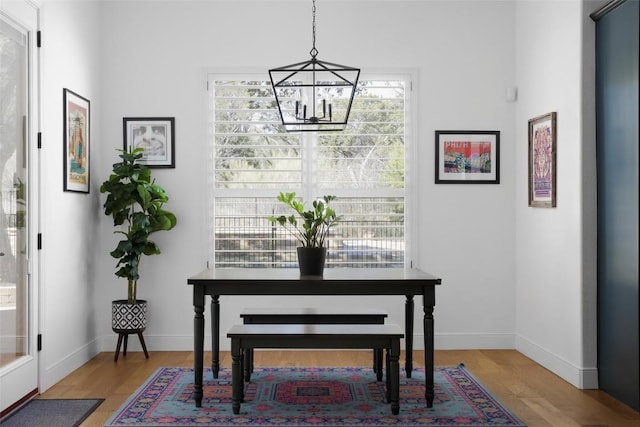 2520 Ionian Cv, Austin, TX 78730 - dining area featuring a chandelier, light wood-style floors, and baseboards