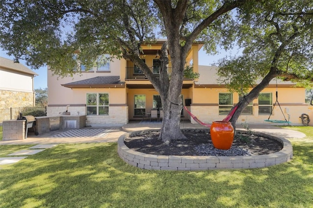 2520 Ionian Cv, Austin, TX 78730 - back of house with an outdoor kitchen, stucco siding, a balcony, and a patio area