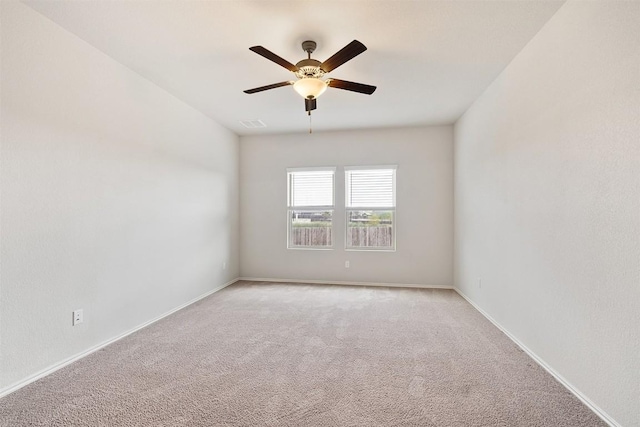 unfurnished room featuring light colored carpet and ceiling fan