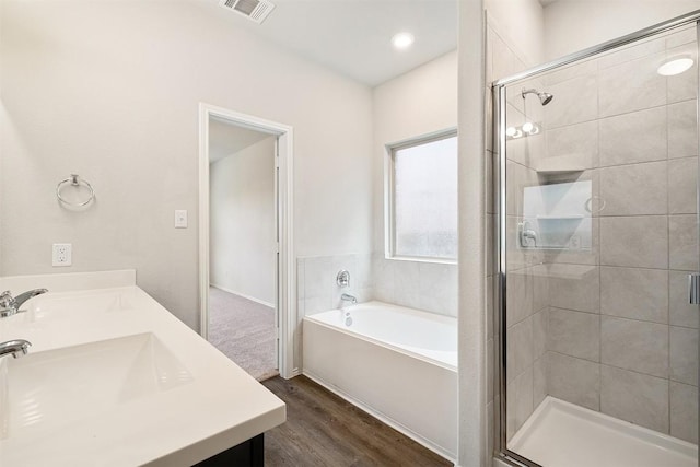 bathroom featuring vanity, hardwood / wood-style flooring, and independent shower and bath