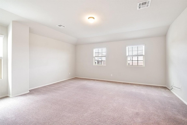 unfurnished room featuring light carpet