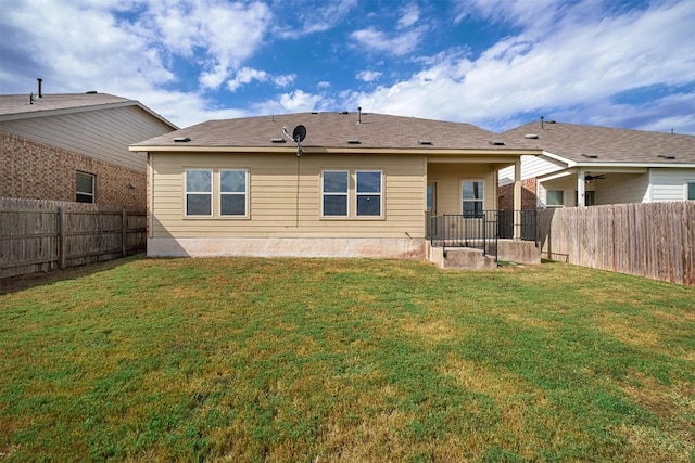 rear view of house with a lawn