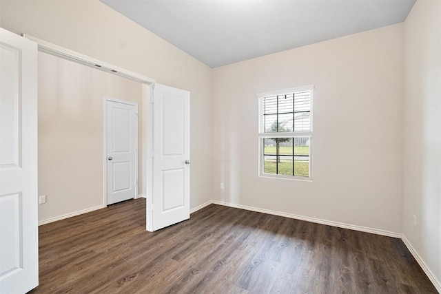 unfurnished bedroom featuring dark wood-type flooring