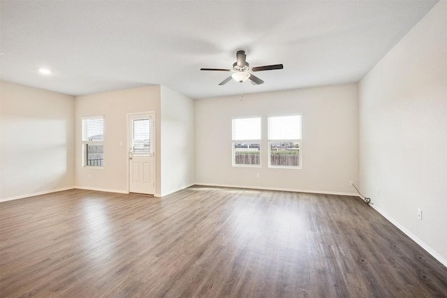 unfurnished room with dark wood-type flooring and ceiling fan