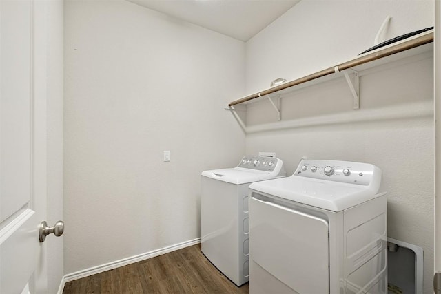 laundry area with separate washer and dryer and dark hardwood / wood-style floors