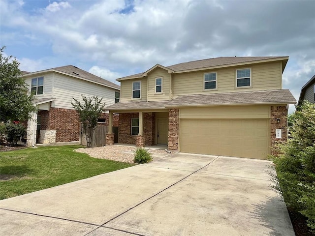 traditional home featuring a front yard, brick siding, a shingled roof, an attached garage, and driveway