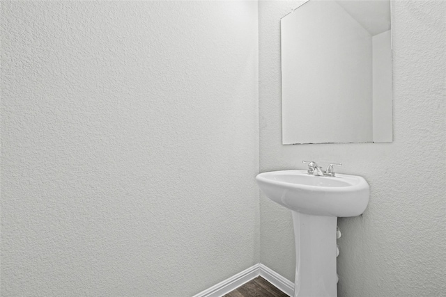 bathroom with hardwood / wood-style flooring and sink