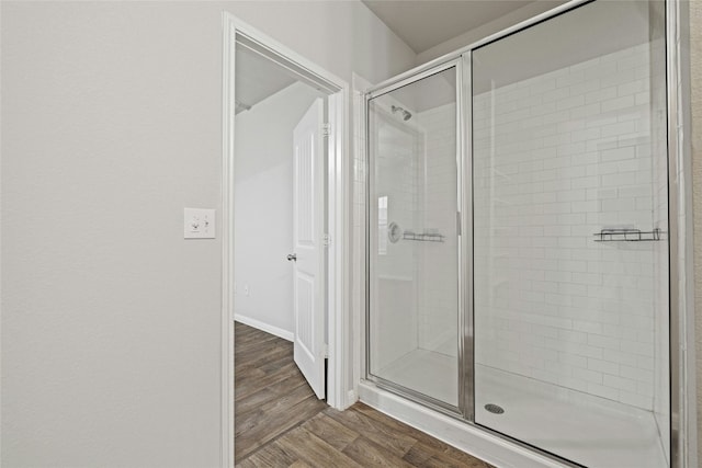 bathroom featuring hardwood / wood-style floors and walk in shower