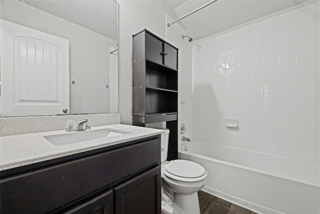 full bathroom featuring vanity, toilet, tiled shower / bath combo, and hardwood / wood-style floors