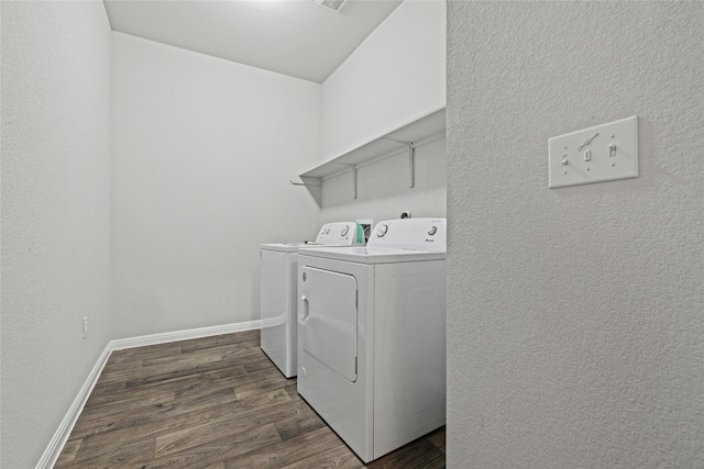 laundry room with dark wood-type flooring and washer and dryer