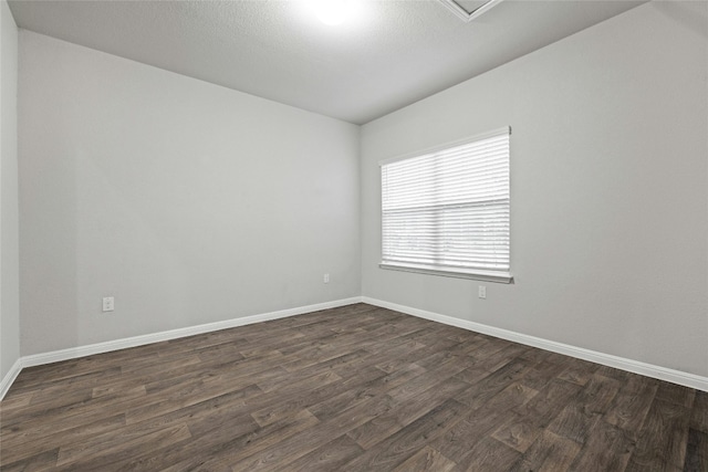 spare room with dark hardwood / wood-style flooring