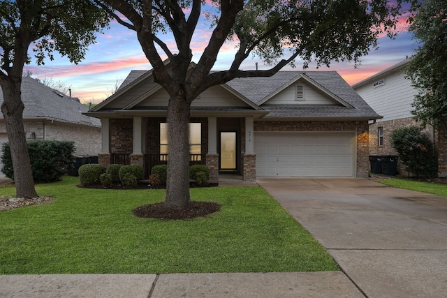 view of front of house featuring a front yard, roof with shingles, a porch, an attached garage, and concrete driveway