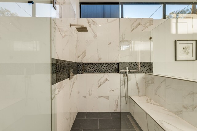 bathroom with tile walls and walk in shower