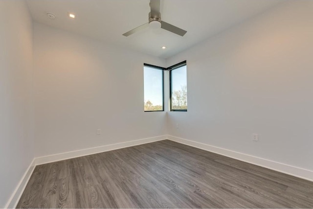 unfurnished room featuring dark hardwood / wood-style flooring and ceiling fan