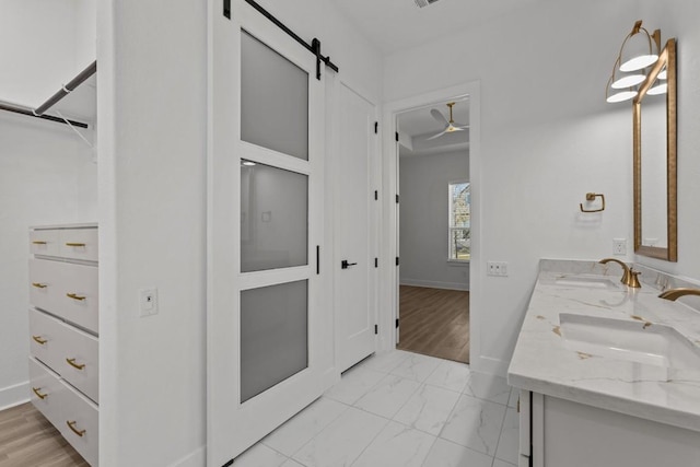 bathroom with ceiling fan and vanity