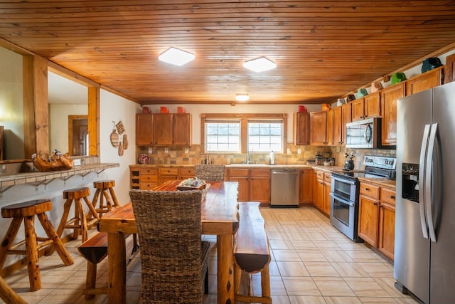 kitchen featuring sink, tasteful backsplash, wood ceiling, light tile patterned floors, and stainless steel appliances