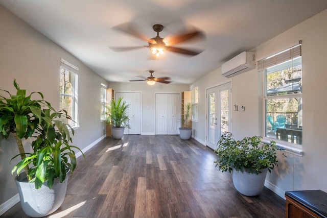 foyer entrance featuring dark wood-type flooring, a wall unit AC, and french doors