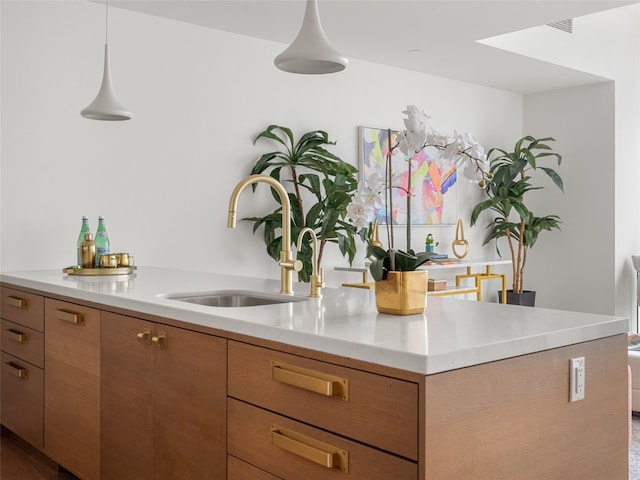 70 Rainey St Unit 1705, Austin, TX 78701 - kitchen with a sink, light countertops, brown cabinetry, and modern cabinets