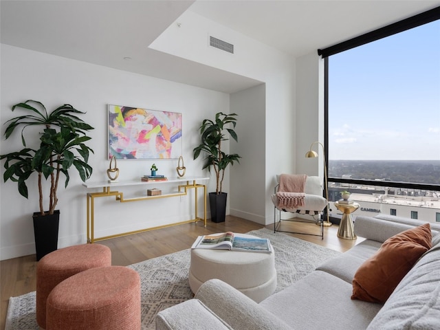 70 Rainey St Unit 1705, Austin, TX 78701 - living area with expansive windows, wood finished floors, and baseboards