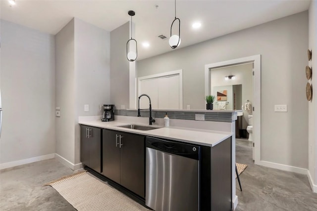 kitchen featuring pendant lighting, stainless steel dishwasher, kitchen peninsula, and sink