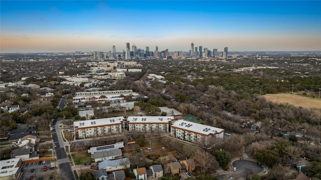 aerial view at dusk featuring a city view