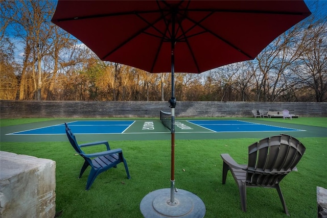 view of home's community with a yard and fence