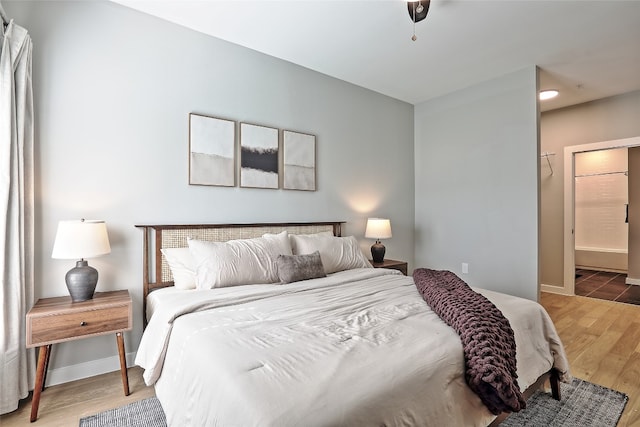 bedroom featuring baseboards and wood finished floors