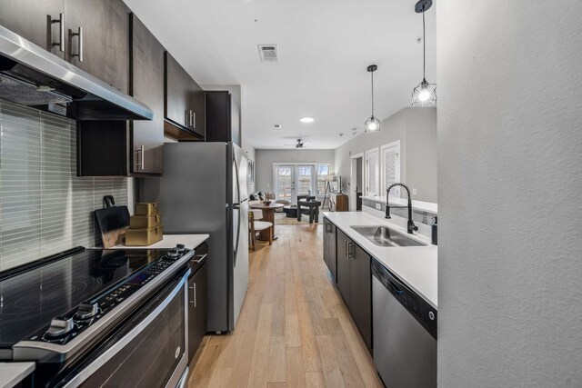 2505 Thornton Rd Unit 1110, Austin, TX 78704 - kitchen featuring dishwasher, a sink, electric range oven, ventilation hood, and tasteful backsplash