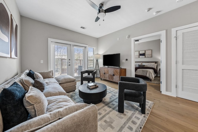 2505 Thornton Rd Unit 1110, Austin, TX 78704 - living room with light wood-style flooring, french doors, and a ceiling fan