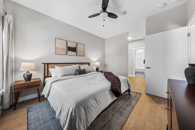 bedroom with light wood-style flooring, baseboards, and a ceiling fan